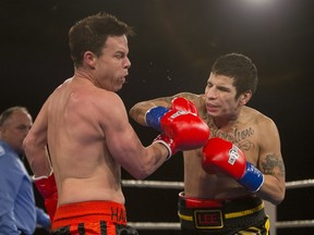 Noel Harding, left, is punched by Lee Laquette during the At Last: Championship boxing at Prairieland Park on Saturday, February 27th, 2016.