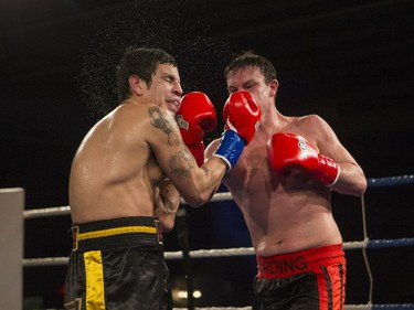 Noel Harding, right, lands a punch on Lee Laquette during the At Last: Championship boxing at Prairieland Park on Saturday, February 27th, 2016.