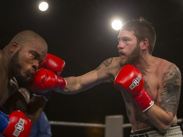 Paul Bzdel (R) lands a punch on Shaklee Phinn during the main event of At Last: Championship boxing at Prairieland Park, February 27, 2016.