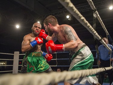 Paul Bzdel, right, lands a punch from Shaklee Phinn during the main event of At Last: Championship boxing at Prairieland Park on Saturday, February 27th, 2016.