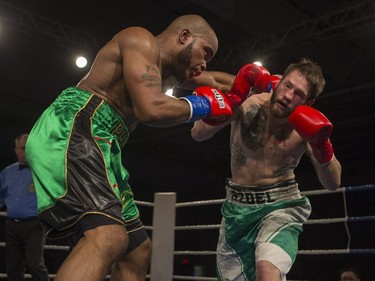 Paul Bzdel, right, takes a punch from Shaklee Phinn during the main event of At Last: Championship boxing at Prairieland Park on Saturday, February 27th, 2016.