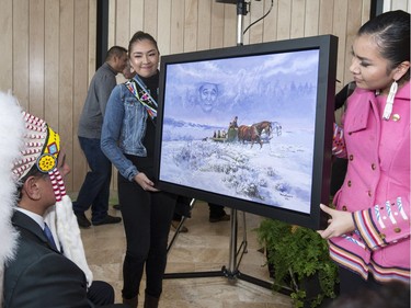 Gordon Oakes' granddaughters Laryn and Mallary Oakes display the painting unveiled at the ceremony at the grand opening celebrations for Gordon Oakes Red Bear Student Centre at the University of Saskatchewan, February 3, 2016.