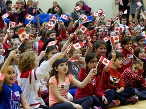 Schoolchildren were excited with their Canadian flags in hand as staff, students and parents at Ecole St. Matthew School kicked off a fundraising campaign to privately sponsor a refugee family, February 4, 2016.