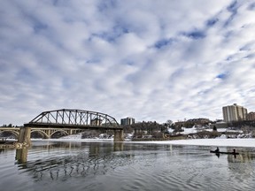 This pair of canoeists pauses before going under the last span standing of the Traffic Bridge after the north section was blown up off the pier, February 8, 2016.
