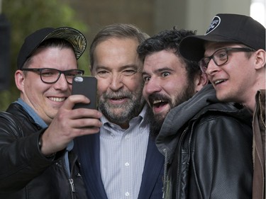Tom Mulcair is grabbed for a selfie by university students  Myron Sydoruk, Jeremy Hurdles and Adam Zambory just after his media interviews kicking off his pre-budget consultation tour in Saskatoon with Saskatoon MP Sheri Benson by his side at the Agriculture Building on the U of S campus, February 9, 2016.