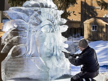 Saskatoon ice sculptor Doug Lingelbach works on an ice sculpture of a First Nation chief for the people of La Loche in WinterShines' Frosted Garden in the Bessborough Gardens area, January 27, 2016.