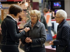 Karen Charyna talks to seniors Carroll Best and Agnes Sebry at Market Mall during a Christmas season event.