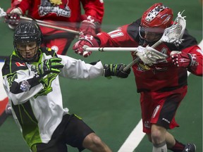 Jeremy Thompson of the Saskatchewan Rush, left mixes it up with Greg Harnett of the Calgary Roughnecks during a recent NLL game in Saskatoon.