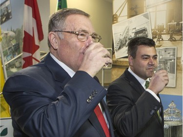 Saskatoon Eastview MLA Corey Tochor (R), on behalf of Government Relations Minister Jim Reiter, and Saskatoon Mayor Donald Atchison drink treated water for guests at an event to celebrate the completion of the City of Saskatoon Water Reservoir Expansion Project on Avenue H South, February 8, 2016. A tour of the facility followed ceremonies.