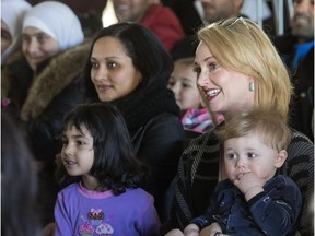 Canadian singer-songwriter Elly Thorn, at right holding son Samuel Nasser, officially launched a new music video You Didn't Even Know Me during an event in Saskatoon, Friday, February 12, 2016. . All proceeds from the song are going to organizations helping with Syrian refugees.