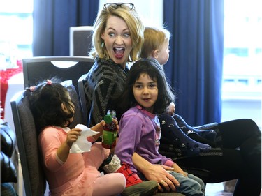 Canadian singer-songwriter Elly Thorn, enjoying a candid moment with Syrian children Ameenah Z'laban (L) and Tayma Ahmad, officially launched a new music video You Didn't Even Know Me during an event in Saskatoon, February 12, 2016. All proceeds from the song are going to organizations helping with Syrian refugees.