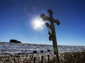 A memorial at the scene of the crash that killed three people west of Langham early Monday morning.