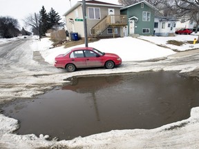 A large puddle covering the intersection of Avenue Q and 18th Street West required some innovating for drivers who used the sidewalk and shoulder in order to get by on February 25, 2016.