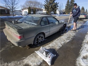 Aiden Rosvold was using pots of hot water, salt and an ice chipper to try and free his vehicle from the ice which had frozen in his rims for the past two days on Broadway Avenue, Friday, February 26, 2016.