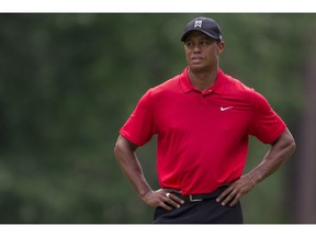FILE - In this Sunday, Aug. 23, 2015, file photo, Tiger Woods pauses on the fifth hole during the final round of the Wyndham Championship golf tournament at Sedgefield Country Club in Greensboro, N.C. Woods announced he underwent a second microdiscectomy surgery on his back on Wednesday, Sept. 16.