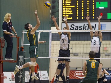 University of Saskatchewan Huskies Andrew Nelson, centre, and blocker Robert Graham attempt to block a hit from University of Regina Cougars Matthew Lueck in CIS Men's Volleyball action on Saturday, February 20th, 2016.