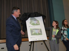 With the help of several students, Education Minister Don Morgan can be seen unveiling the final design plans for one of the 18 new joint-use schools that will be constructed in Saskatchewan at Lakeridge School on Monday, Feb. 22, 2016.