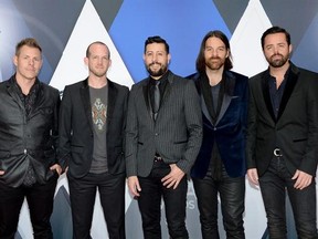 FILE - In this Nov. 4, 2015, file photo, members of Old Dominion, from left, Trevor Rosen, Whit Sellers, Matthew Ramsey, Geoff Sprung and Brad Tursi arrive at the 49th annual CMA Awards at in Nashville, Tenn. When members of the band saw their name on the voting ballots for the 51st Academy of Country Music Awards that will be held Sunday, April 3, 2016, for both new vocal duo/group of the year and vocal group of the year, the whole thing felt like a joke on them. (Photo by Evan Agostini/Invisio