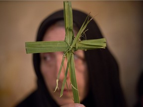 A Greek Orthodox woman holds a palm fond in the Church of the Holy Sepulcher, traditionally believed by many to be the site of the crucifixion and burial of Jesus Christ, during Orthodox Palm Sunday, in Jerusalem, Sunday, April 5, 2015. Christians in the Holy Land and across the world are celebrating Easter, commemorating the day followers believe Jesus was resurrected in Jerusalem 2,000 years ago.