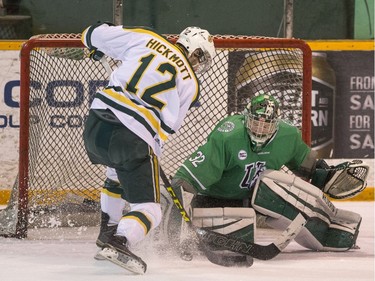 University of Saskatchewan Huskies goalie Jordon Cooke stops a break away chance from University of Alberta Golden Bears forward Jordan Hickmott during second period CIS Men's Hockey action on March 5.