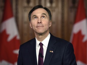 Minister of Finance Bill Morneau looks up in the foyer of parliament as he participates in TV interviews after tabling the federal budget on Parliament Hill in Ottawa on Tuesday, March 22, 2016.