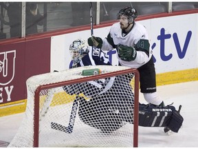 University of Saskatchewan Huskies' Logan McVeigh runs into St. Francis Xavier X-Men goaltender Drew Owsley in first-period hockey championship action in Halifax on Saturday, March 19, 2016.