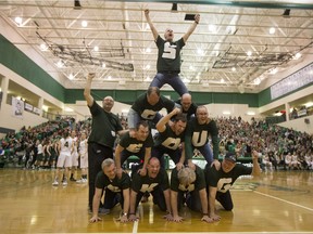 The dads of the University of Saskatchewan Huskies build a human pyramid during the Canada West final Saturday at the PAC. (Liam Richards/Saskatoon StarPhoenix)