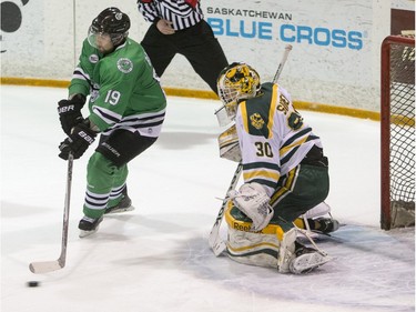 University of Saskatchewan Huskies forward Kohl Bauml attempts to redirect a shot on University of Alberta Golden Bears goalie Luke Siemens during 2nd period CIS Men's Hockey action on Saturday, March 5th, 2016.