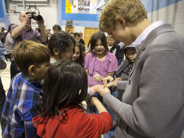 Jan Lisiecki, classical pianist, signs autographs for students at Senator Myles Venne elementary school in La Ronge during a Cameco sponsored tour of northern Saskatchewan on March 3, 2016.