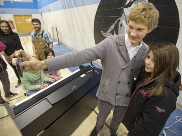 Jan Lisiecki, classical pianist, poses for a selfie with a student from Senator Myles Venne elementary school after his performance in La Ronge during a Cameco sponsored tour of northern Saskatchewan on March 3, 2016.