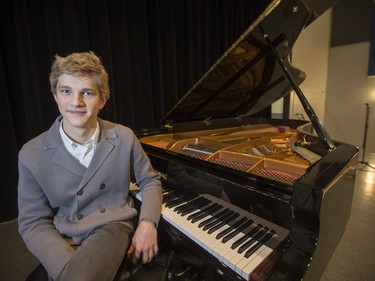 Jan Lisiecki, classical pianist, poses for a photograph at the piano he will playing at Churchill Community School in La Ronge later in the day during a Cameco sponsored tour of northern Saskatchewan on March 3, 2016.
