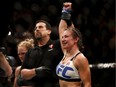 Miesha Tate, right, celebrates victory over Holly Holm during their UFC 196 women's bantamweight mixed martial arts match, Saturday, March 5, 2016, in Las Vegas.