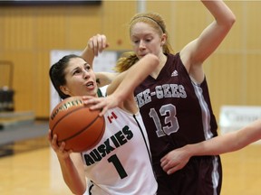 Desarae Hogberg (1) gets smothered by an Ottawa Gee-Gees defender during CIS Final 8 tournament action in Fredericton, N.B.