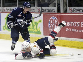 Pats Sean Richards is up ended by blades Logan Christensen during WHL action between the Regina Pats and Saskatoon Blades at the Brandt Centre in Regina Wednesday night.