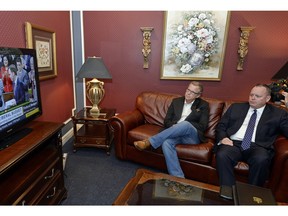 Premier Brad Wall and finance minister Kevin Doherty in Regina watch the federal budget being delivered Tuesday.