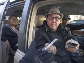 Kim Beaudin, president of the Aboriginal Affairs Coalition of Saskatchewan with friends, hands his drivers license in a photo illustration of the issues facing some residents in Saskatoon around carding and street checks, March 10, 2016.