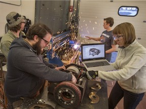 Saskatoon's (front) Kyle Isfan and Julia Chernushevich, (back) (L) Brian Hales and Nicholas Wachniak in their shop con tuning to work on Bucktooth Burl, a robot, which will compete in the 2nd season of Battlebots on ABC later this year, March 10, 2016.