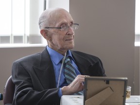 Henry Wiegers sits at the head table with five others as they all celebrate their 100th birthday party at the Palisades highrise on Saturday, March 12th, 2016.