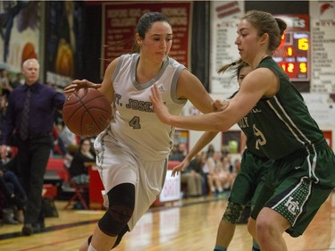 St. Joseph Guardians Alli Bristow moves the ball against the Holy Cross Crusaders in the City girls high school basketball city final at Bedford Road Collegiate on Saturday, March 12th, 2016.