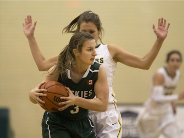 University of Saskatchewan Huskies guard Madeline Humbert moves the ball against the University of Regina Cougars in the Canada West final in CIS action, March 12, 2016.