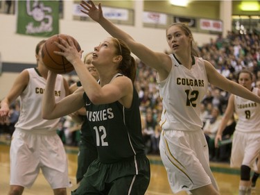 University of Saskatchewan Huskies guard Kelsey Trulsrud moves the ball against the University of Regina Cougars in the Canada West final in CIS action on March 12, 2016.