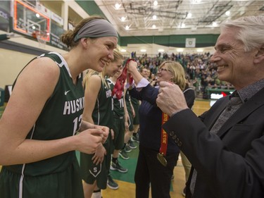 University of Saskatchewan Huskies forward Dalyce Emmerson is given a gold medal by U of S President Peter Stoicheff after they defeat the University of Regina Cougars in the Canada West final in CIS action, March 12, 2016.