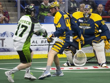 Saskatchewan Rush forward Robert Church takes a shot on Georgia Swarm goalie Brodie MacDonald in NLL Lacrosse action, March 12, 2016.