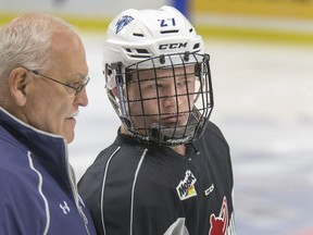 Saskatoon Blades assistant coach Jerome Engele skates with 15-year-old Payton McIaac, who has been with the team for the past month.