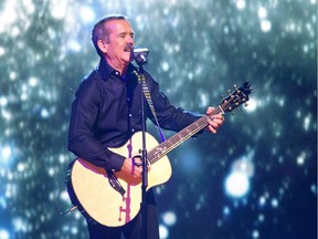 Chris Hadfield plays guitar and sings on stage at WeDay in Saskatoon, March 2, 2016.