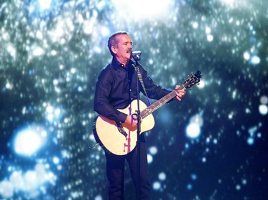 Canadian astronaut Chris Hadfield plays guitar and sings on stage at WeDay at SaskTel Centre in Saskatoon, March 2, 2016.