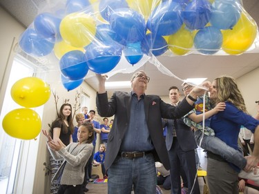 Sask Party leader Brad Wall opens a bag of balloons to celebrate the grand opening of the Ability In Me (AIM) Centre, March 21, 2016.