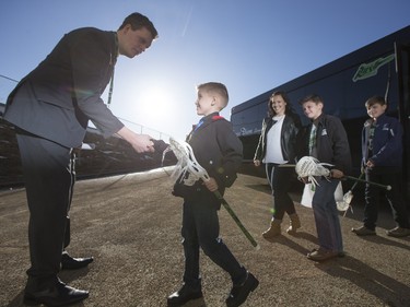 Brad Kraft, Media Relations with the Saskatchewan Rush Lacrosse Club, greets nine-year-old Cohyn Wells as he gets off of a limousine prior to signing a one-day contract with the Saskatchewan Rush, March 26, 2016. Wells is the Saskatchewan representative for the Children's Miracle Network's Champion Program.