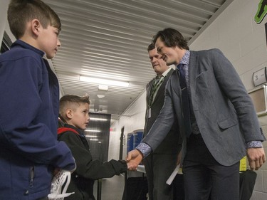 Saskatchewan Rush captain Chris Corbeil greets nine-year-old Cohyn Wells prior to signing a one-day contract with the Saskatchewan Rush, March 26, 2016. Wells is the Saskatchewan representative for the Children's Miracle Network's Champion Program.