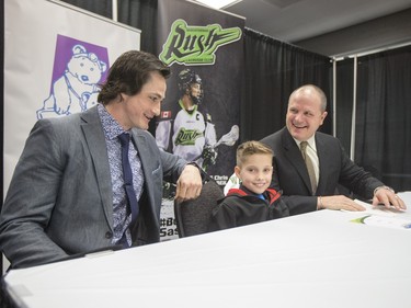 L-R: Saskatchewan Rush captain Chris Corbeil, nine-year-old Cohyn Wells and Rush head coach and general manager Derek Keenan hold a press conference for the signing of a one-day contract of Cohyn to the Saskatchewan Rush, March 26, 2016. Wells is the Saskatchewan representative for the Children's Miracle Network's Champion Program.